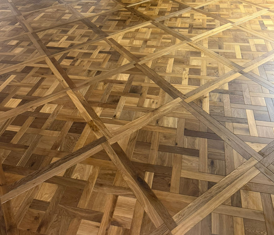 Smoked brushed wood Versailles parquet panel with light and dark interlocking block pattern