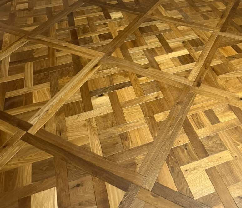 Smoked brushed wood Versailles parquet panel in warm honey tones with diagonal cross lines