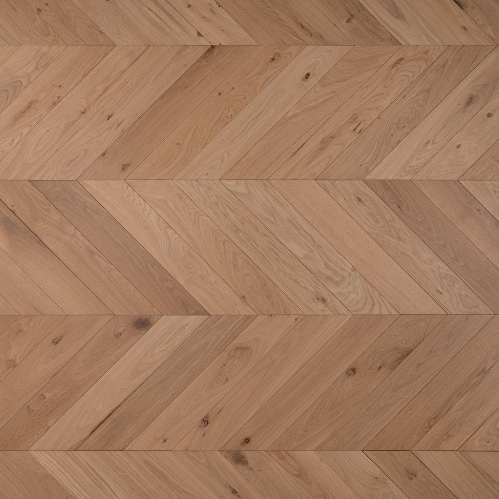 Chevron wood flooring with light natural oiled finish and herringbone pattern.