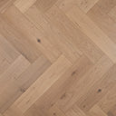 Light oak herringbone wood flooring detail with natural grain and knots