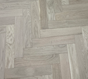 Light oak engineered herringbone flooring with staggered rectangular plank pattern