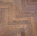 Whiskey oak engineered herringbone wood flooring with narrow plank pattern