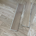 Natural oak engineered herringbone wood flooring planks, close-up showing pattern