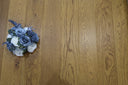 Golden wheat brushed matt wood flooring with long plank grain and visible seams