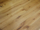 Engineered wood flooring planks, light golden-brown with rustic knots and grain