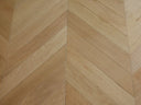 Natural brushed matte wood chevron flooring with interlocking V pattern