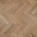 Light wood herringbone flooring pattern with narrow rectangular planks