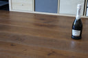 Hazelnut brown engineered wood floor with visible plank seams and smooth finish