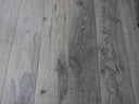 Distressed charcoal grey wood-look hard wax oiled flooring planks with visible grain