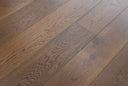 Hazelnut brown wood floor planks with brushed texture, subtle sheen, and grain