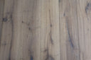 Smoked white engineered wood flooring with knots and blue-gray oiled marks