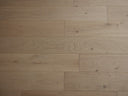 Light oak engineered wood flooring boards with visible knots and matte grain