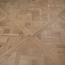 Light oak parquet panel with Versailles geometric inlay pattern and brushed surface texture