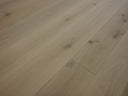 Unfinished engineered wood flooring plank with visible seams and light wood knots