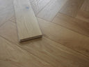 Herringbone wood flooring sample board stack, light wood with brushed matt finish