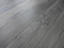 Distressed charcoal grey wood-look hard wax oiled flooring planks with rustic knots