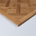 Natural oak parquet wood panel corner with beveled edges, brushed finish