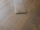 Engineered wood flooring planks with hand-scraped brushed finish and staggered sample strips