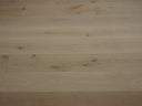 Unfinished engineered wood flooring with smooth light wood boards and subtle grain