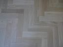 Engineered oiled herringbone wood flooring, light natural planks with visible grain