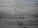 Distressed charcoal grey wood-look hard wax oiled flooring planks with swirling wood grain