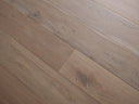 Smoked grey engineered hardwood planks showing natural knots and wood grain