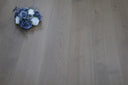 Light grey wood floor planks with visible grain, UV-oiled surface and brushed texture