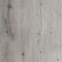Close-up of light gray LVT flooring planks with wood grain and knots
