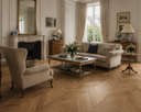 Chevron wood flooring in a living room, natural oak herringbone pattern
