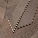 Close-up of chevron wood flooring seams with V-shaped join lines