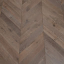 Corner view of chevron wood flooring with staggered plank pattern
