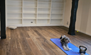 Distressed engineered wood flooring planks, warm brown with textured wear marks