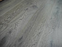 Distressed gray engineered wood flooring with visible plank seams and grain