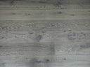 Distressed light gray engineered wood flooring planks with crosswise seam lines