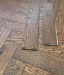 Whiskey oak herringbone engineered wood flooring boards with light-to-dark grain