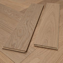 Light oak herringbone wood planks laid next to each other, edge profile visible