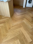 Wood-look herringbone flooring with brushed matt finish, room corner view