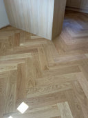 Wood-look herringbone flooring with brushed matt finish, close-up pattern view