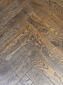 Dark brown engineered herringbone wood flooring planks
