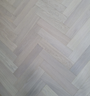 Engineered herringbone wood flooring in light white-oiled finish, parquet pattern