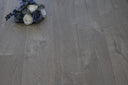 Engineered wood flooring in soft grey fossil stone finish with light wood grain texture