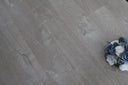 Soft grey engineered wood flooring featuring fossil stone finish and varied wood-grain lines