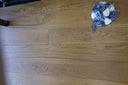 Golden wheat brushed matte lacquer wooden flooring showing plank seams and grain