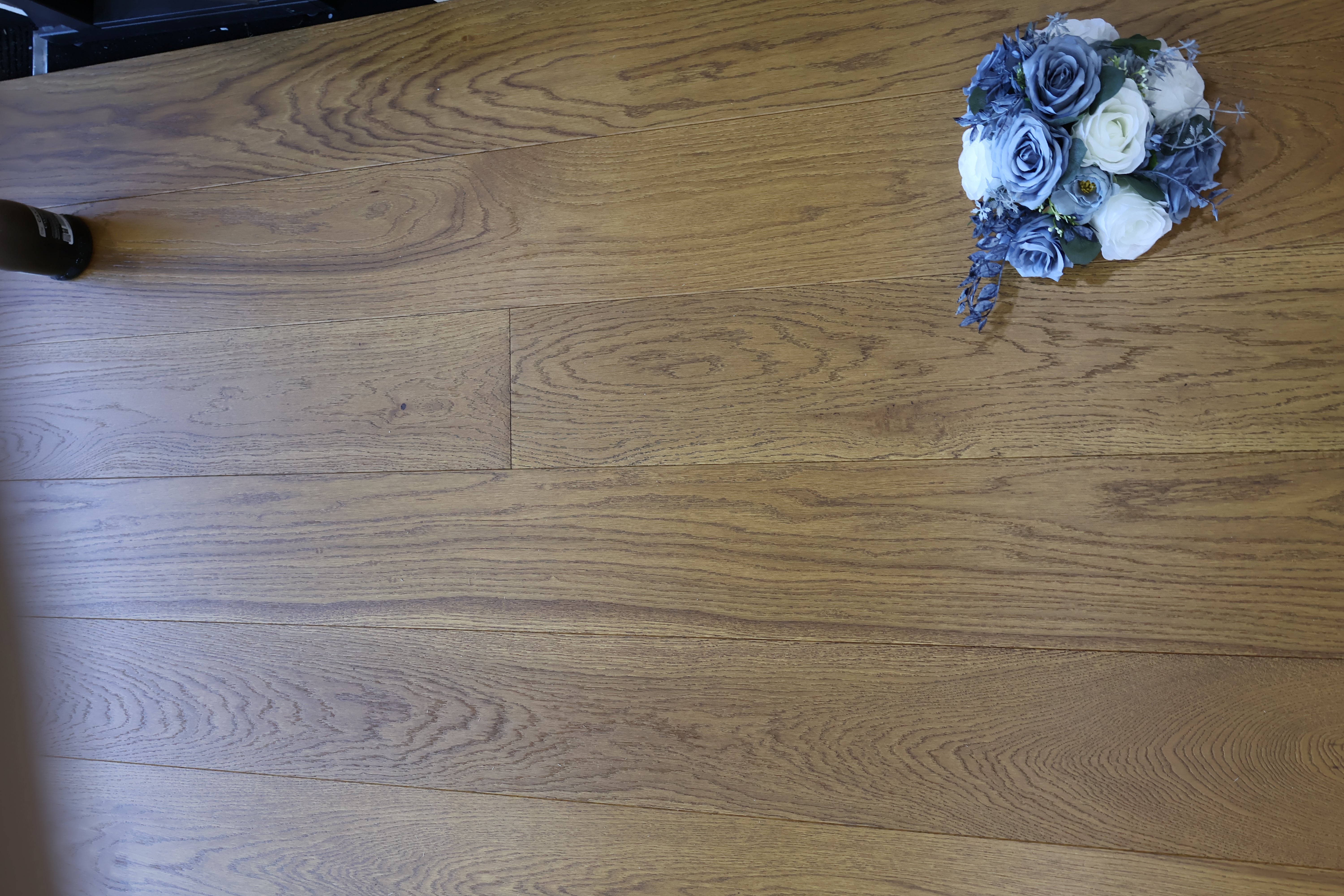 Golden wheat brushed matte lacquer wooden flooring showing plank seams and grain