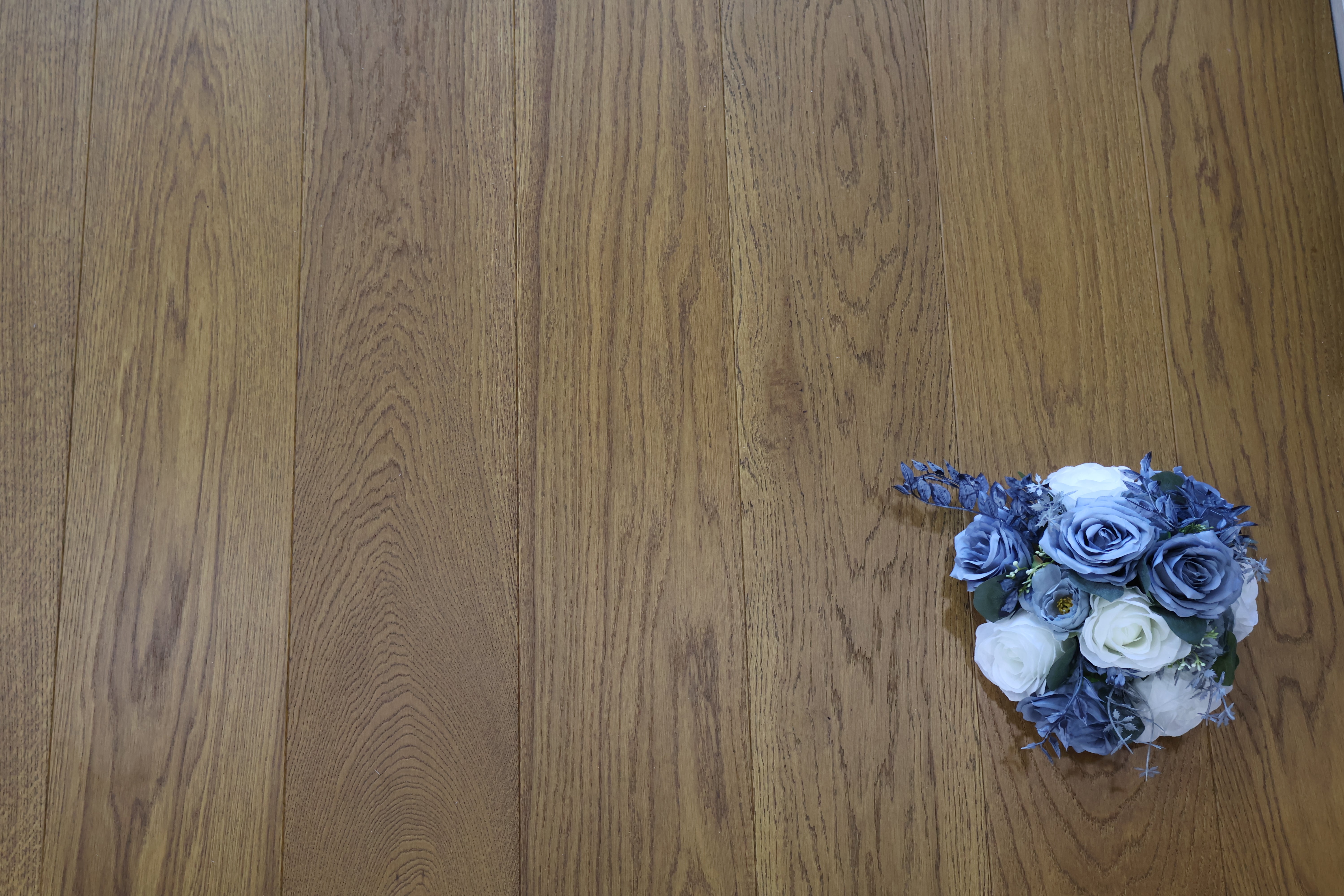 Golden wheat brushed matte lacquer wooden flooring close-up with vertical grain lines