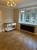 Natural brushed oiled wood parquet floor panels showing Versailles-style block pattern