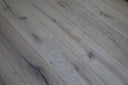 Whitewashed engineered wood flooring planks with brushed matte texture, diagonal close view