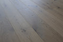 Light oak wood-effect flooring planks with visible knots and matte finish