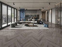 Midnight grey herringbone laminate flooring boards in a wide chevron pattern