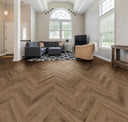Smoked oak herringbone laminate flooring with dark wood-grain chevron pattern